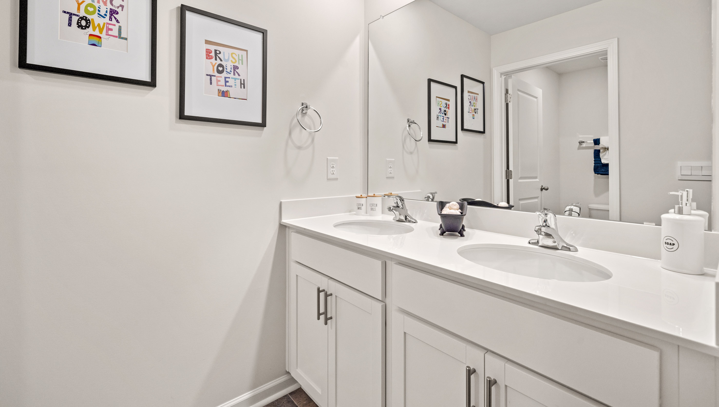 Double sink vanity in bathroom.