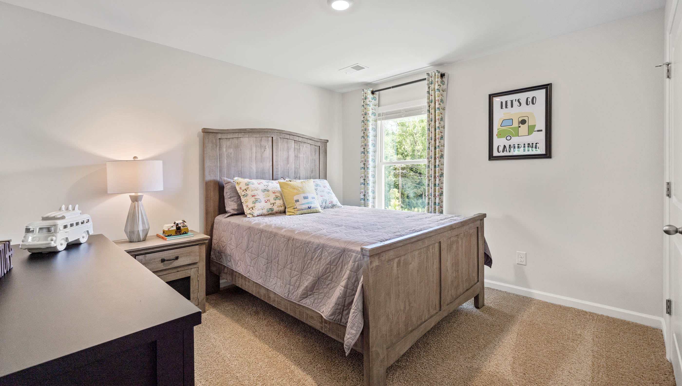 Bedroom with carpet floors and window.