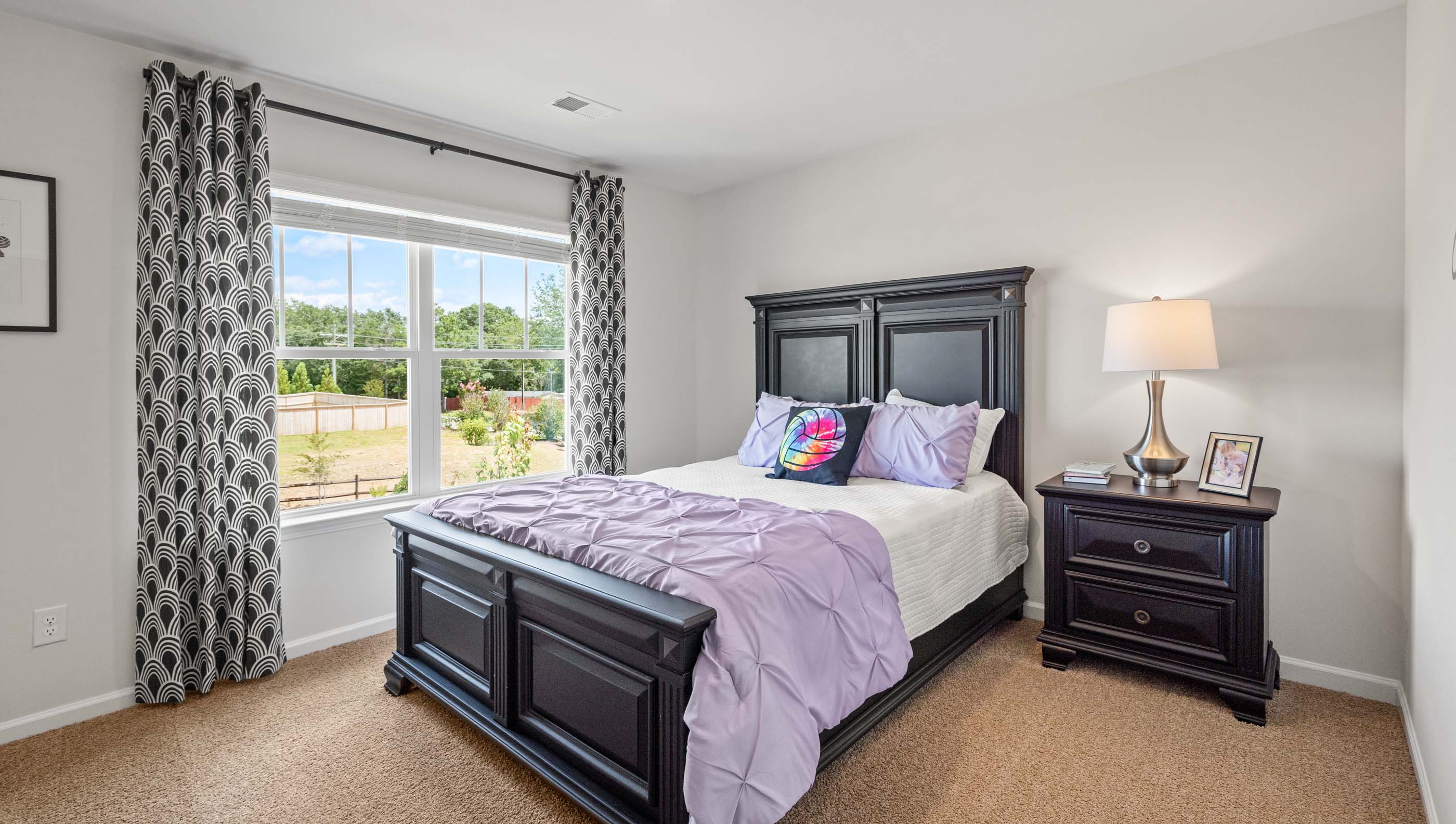 Bedroom with carpet floors and window.