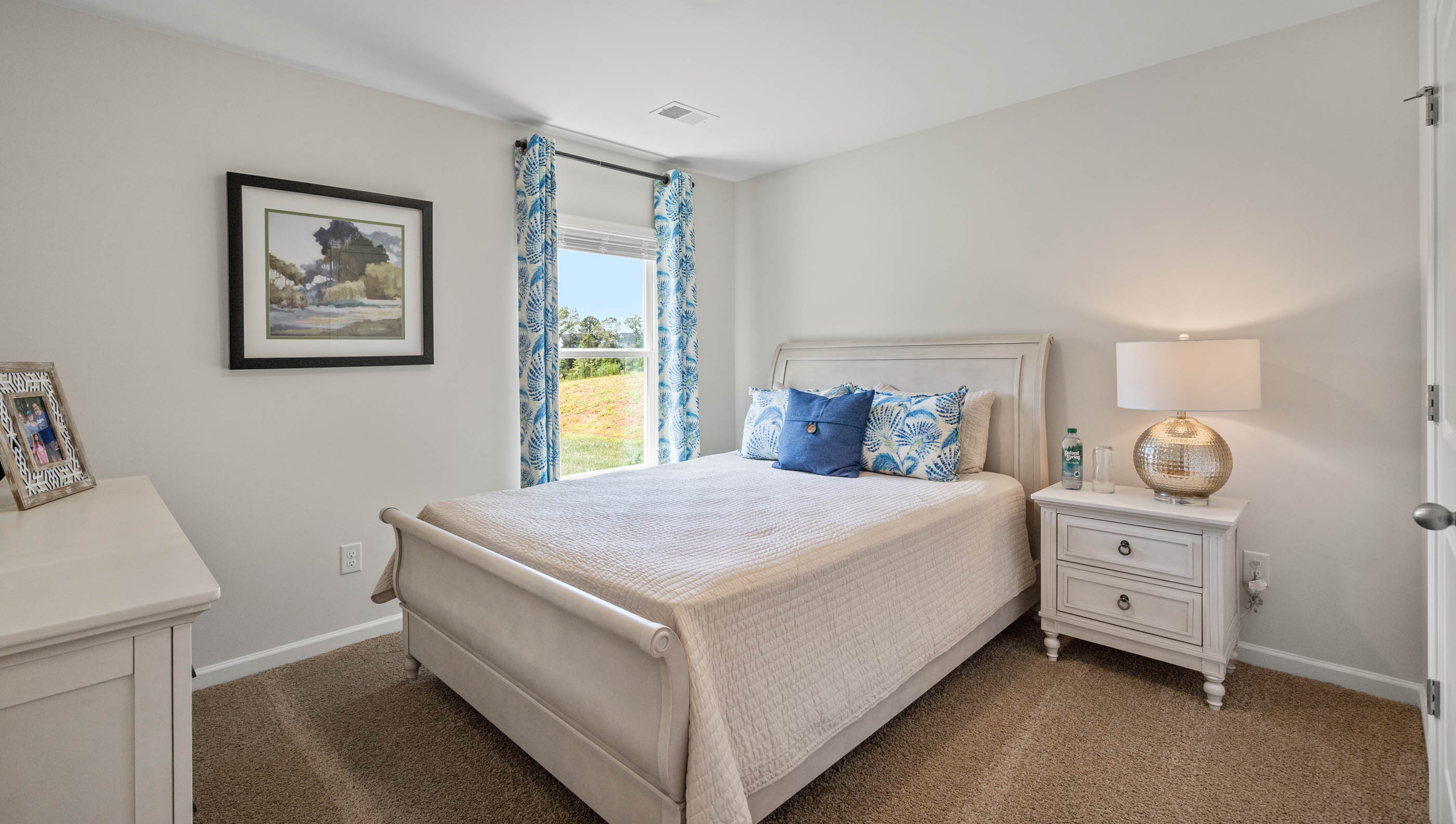 Bedroom with carpet floors and window.
