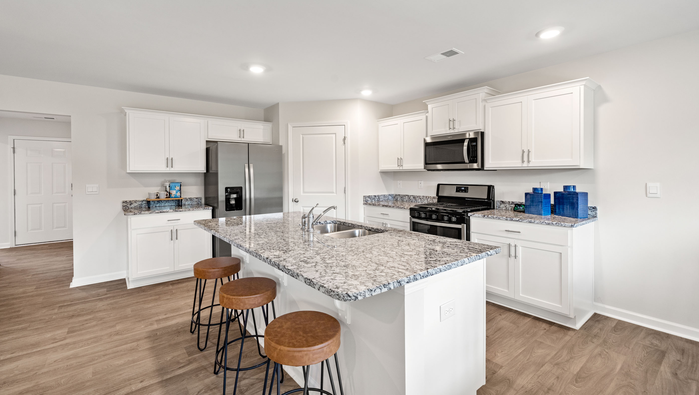 Kitchen and island with granite counter tops.
