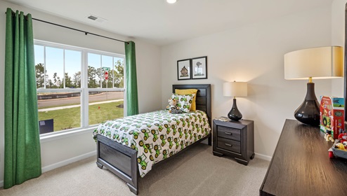 Bedroom with carpet and window.