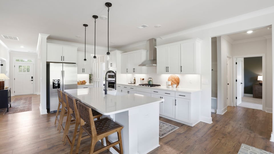 Kitchen with quartz countertops and stainless steel appliances.