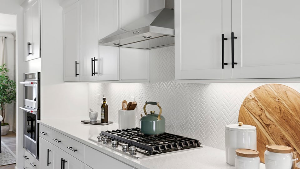 Kitchen with quartz countertops and stainless steel appliances.