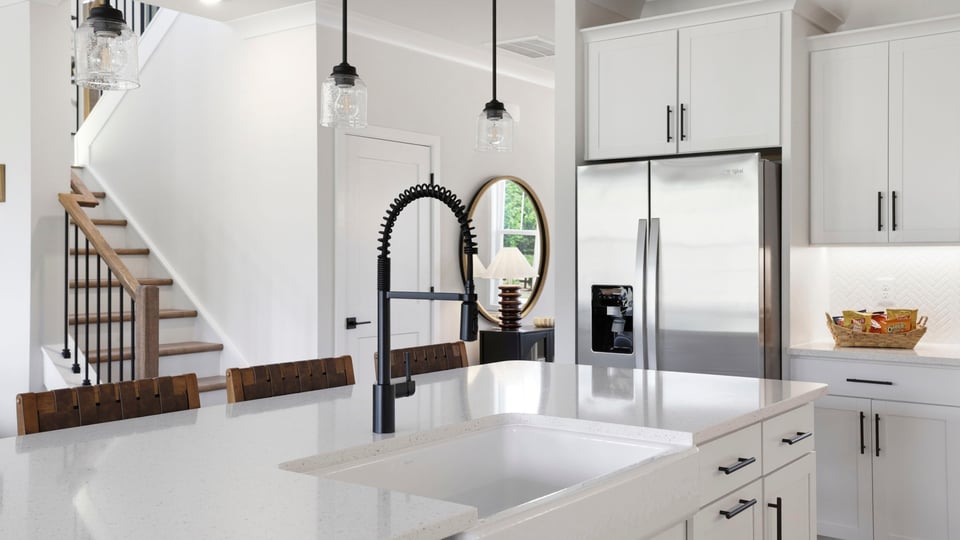 Kitchen with quartz countertops and stainless steel appliances.