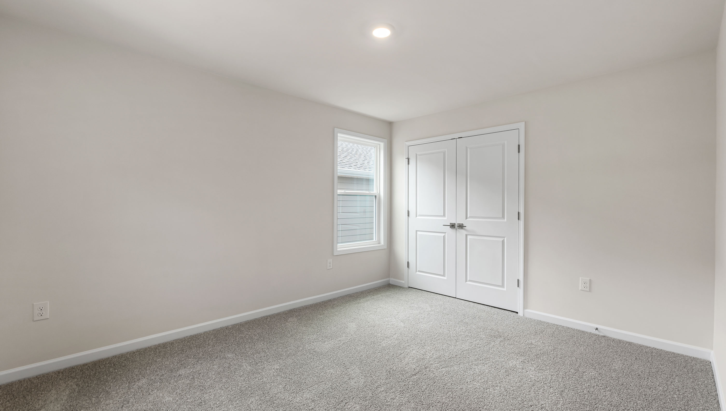 Bedroom with carpet and windows.