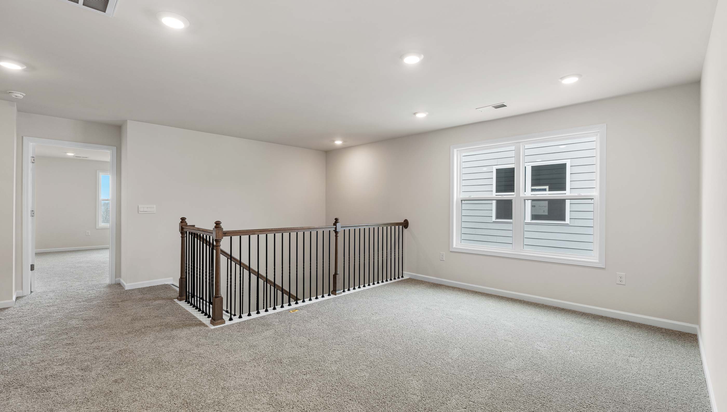 Bedroom with carpet and windows.