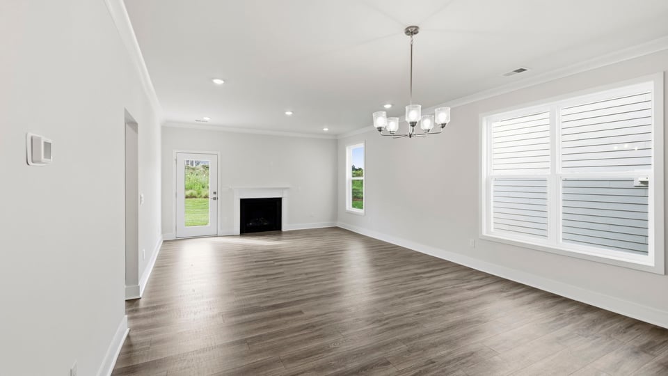 Living room with fireplace and windows.