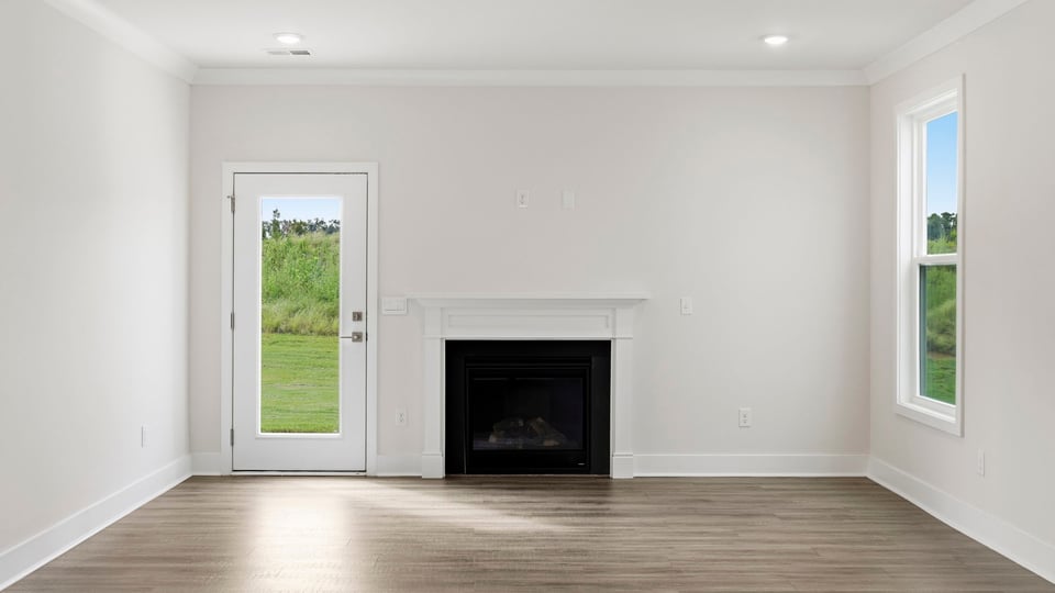 Living room with fireplace and windows.