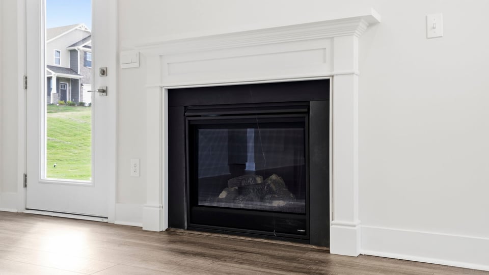 Living room with fireplace and windows.