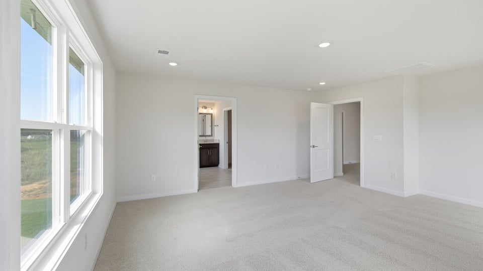 Bedroom with carpet and windows.