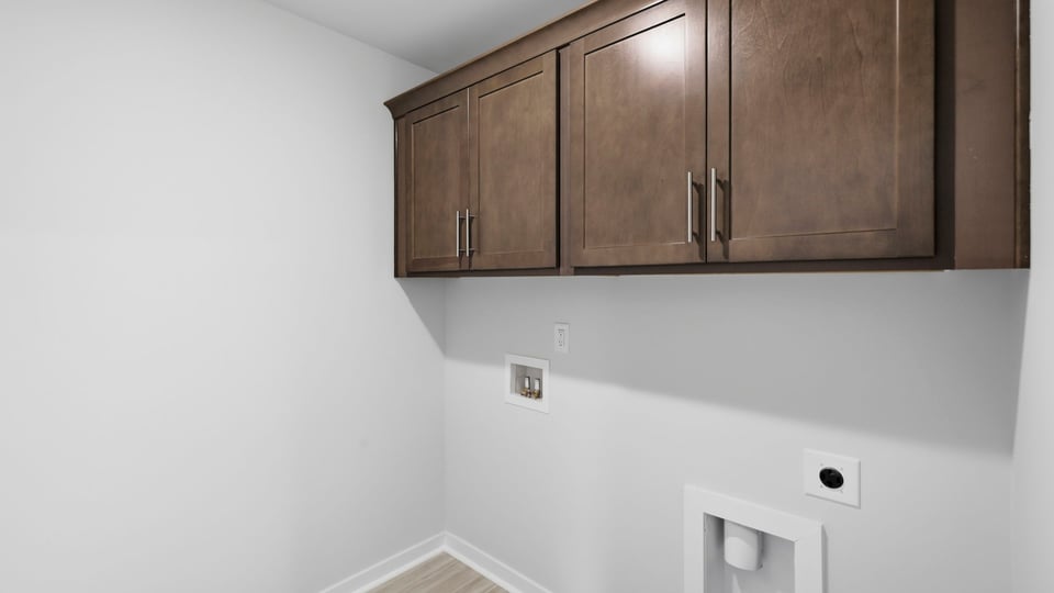 Laundry room with cabinets.
