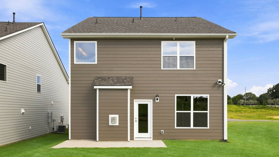 Back exterior with large backyard.