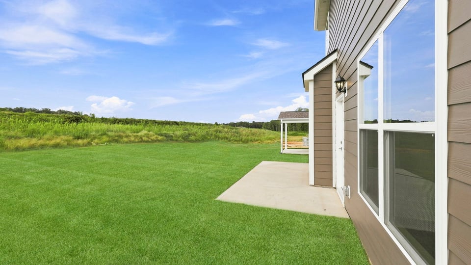 Back exterior with large backyard.