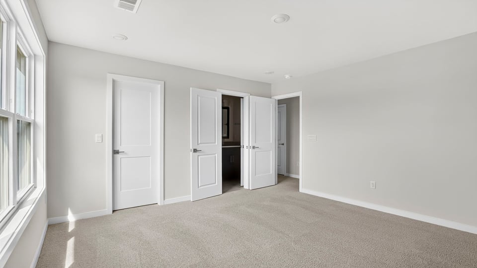 Bedroom with carpet and window.