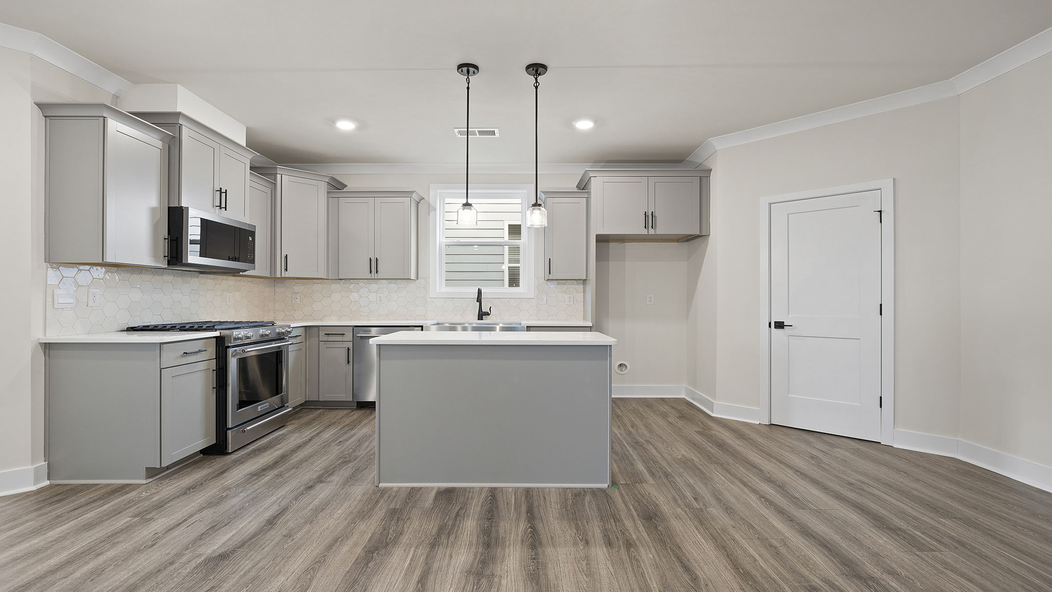 Kitchen with island and cabinets.