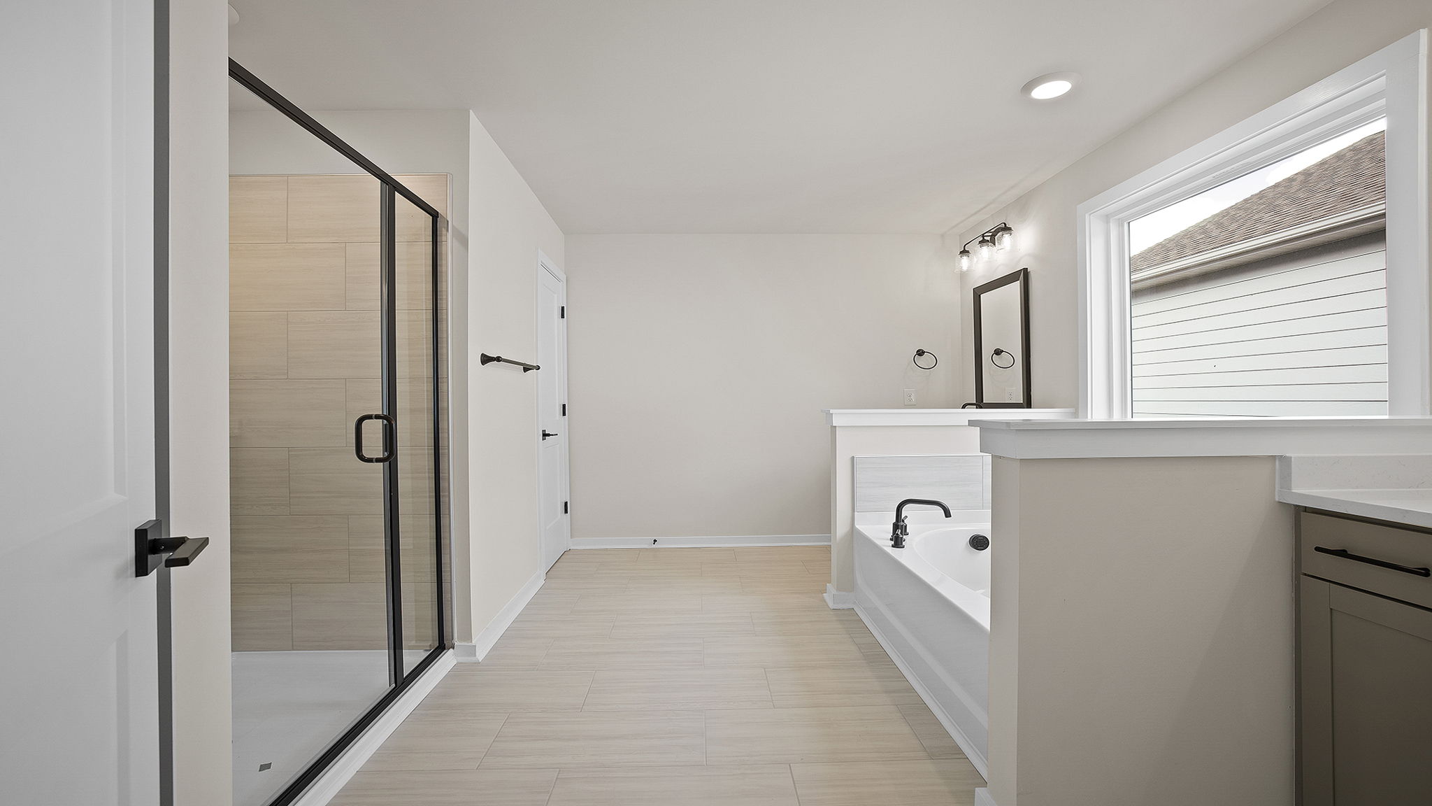 Primary bathroom with tub and walk-in shower.