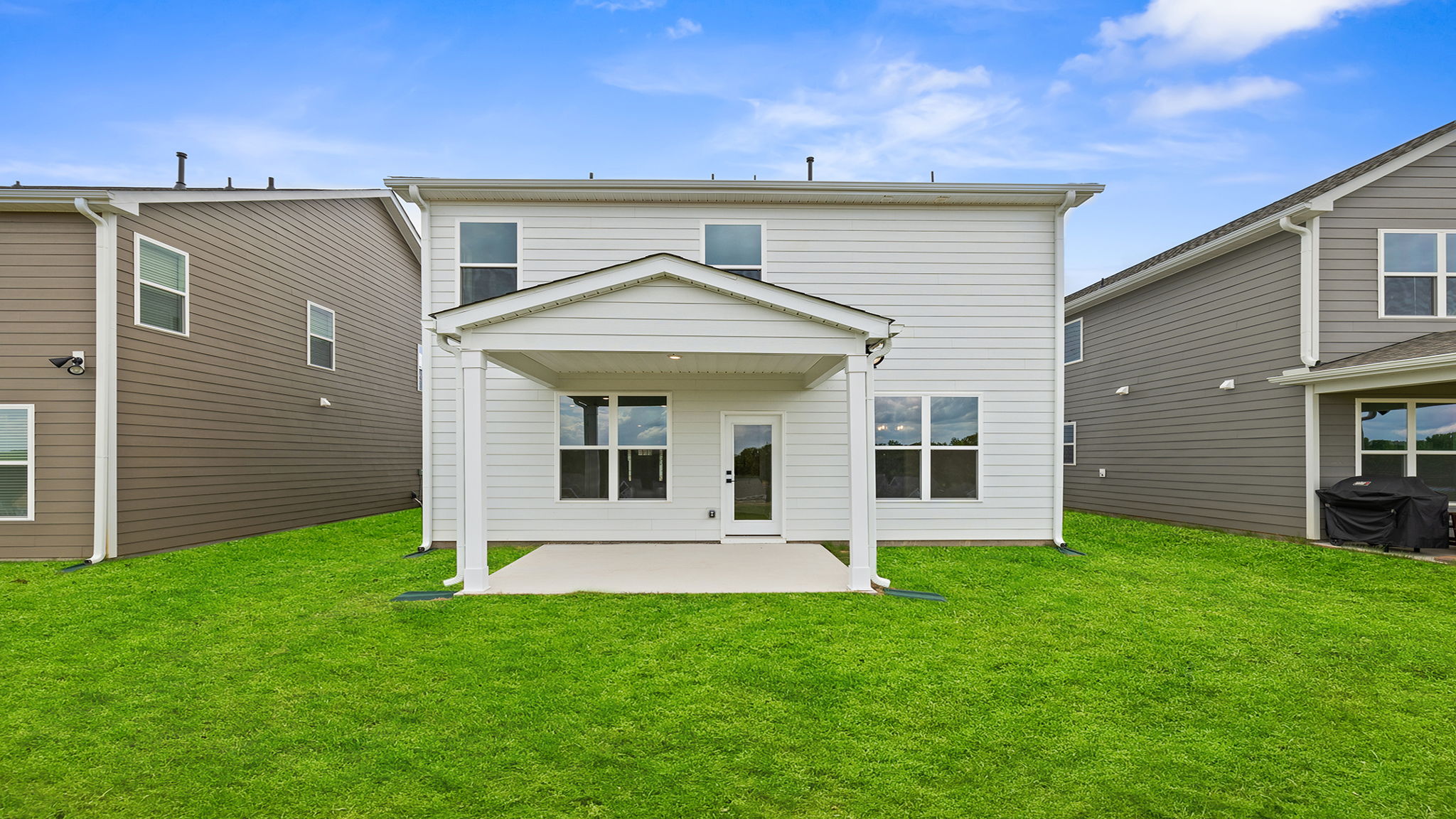 Back exterior with large backyard.