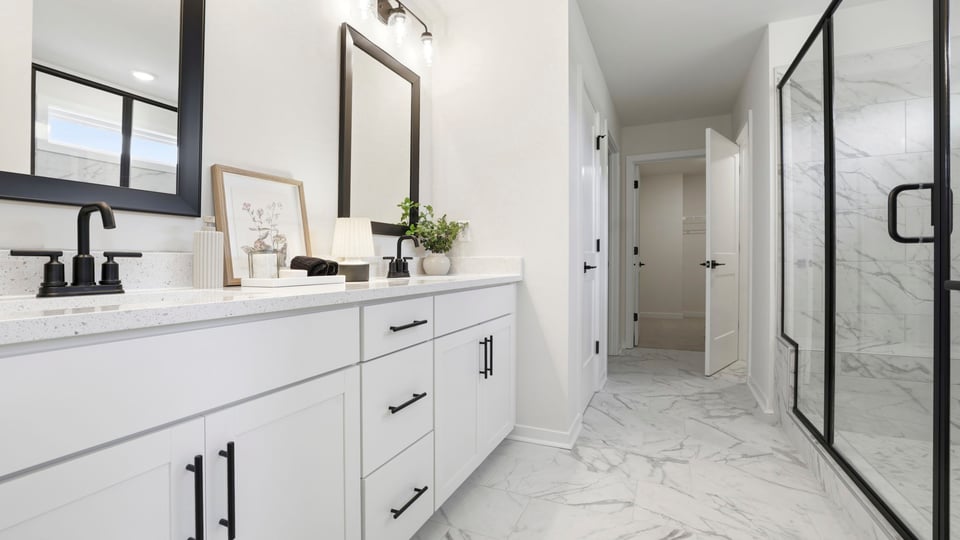 Bathroom with double vanity sink and shower.