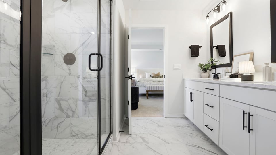 Bathroom with double vanity sink and shower.