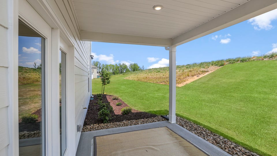 Backe exterior of home with covered patio.