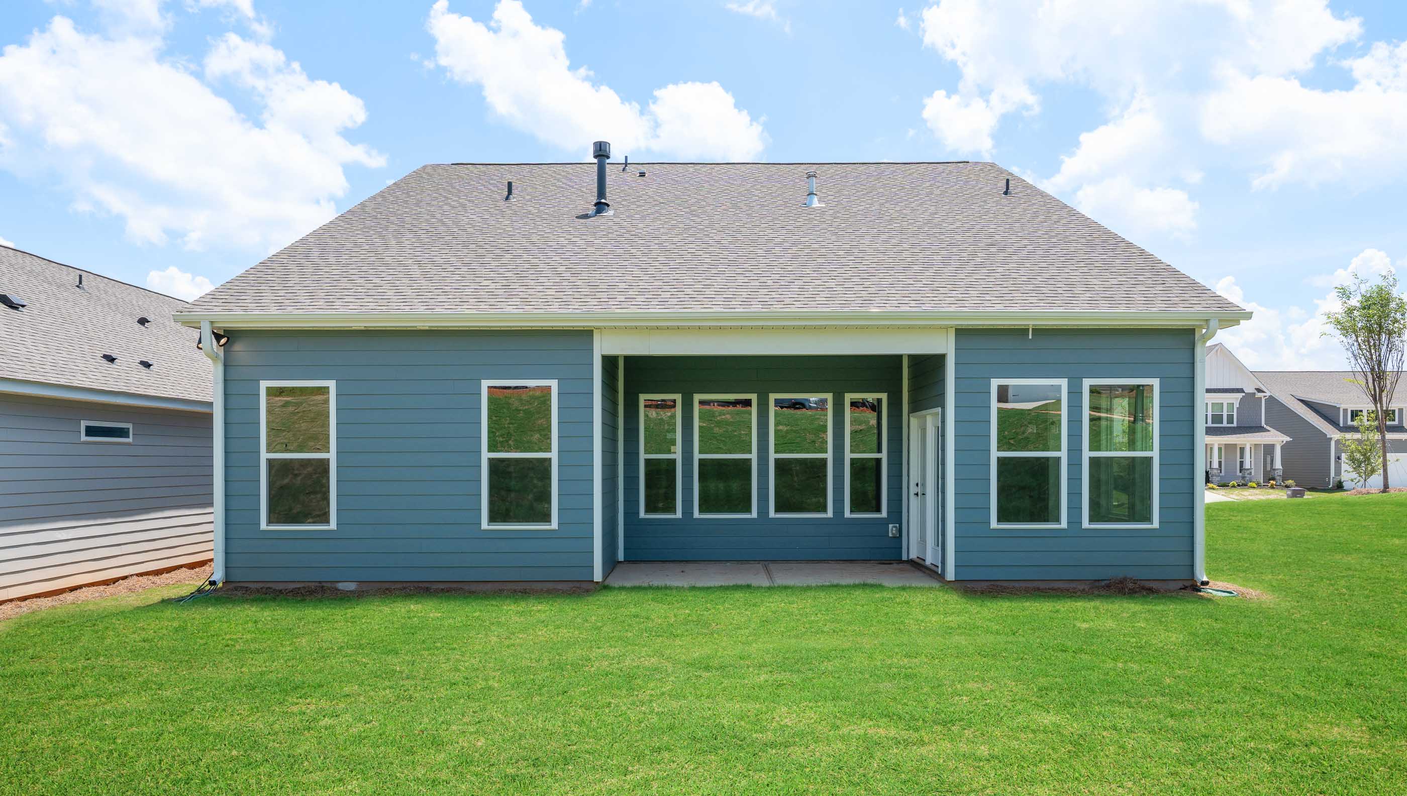 Back exterior of home with large backyard.