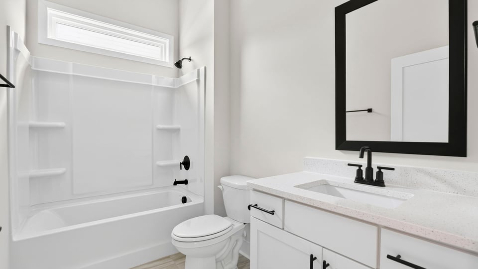 Bathroom with single vanity sink and bathtub.