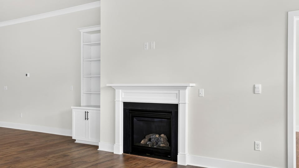 Family room with fireplae and window.