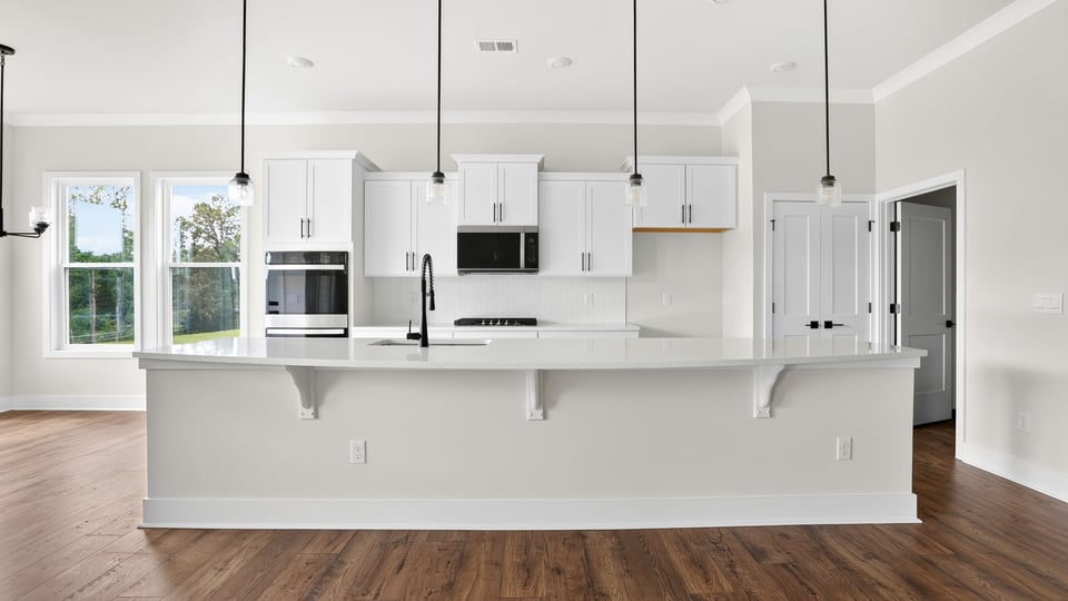 Kitchen and island with quartz countertops.