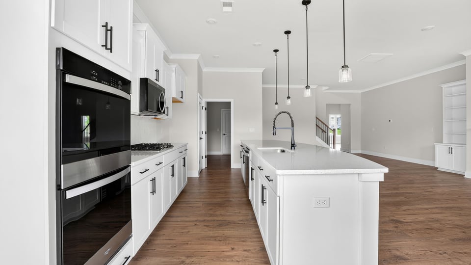 Kitchen and island with quartz countertops.