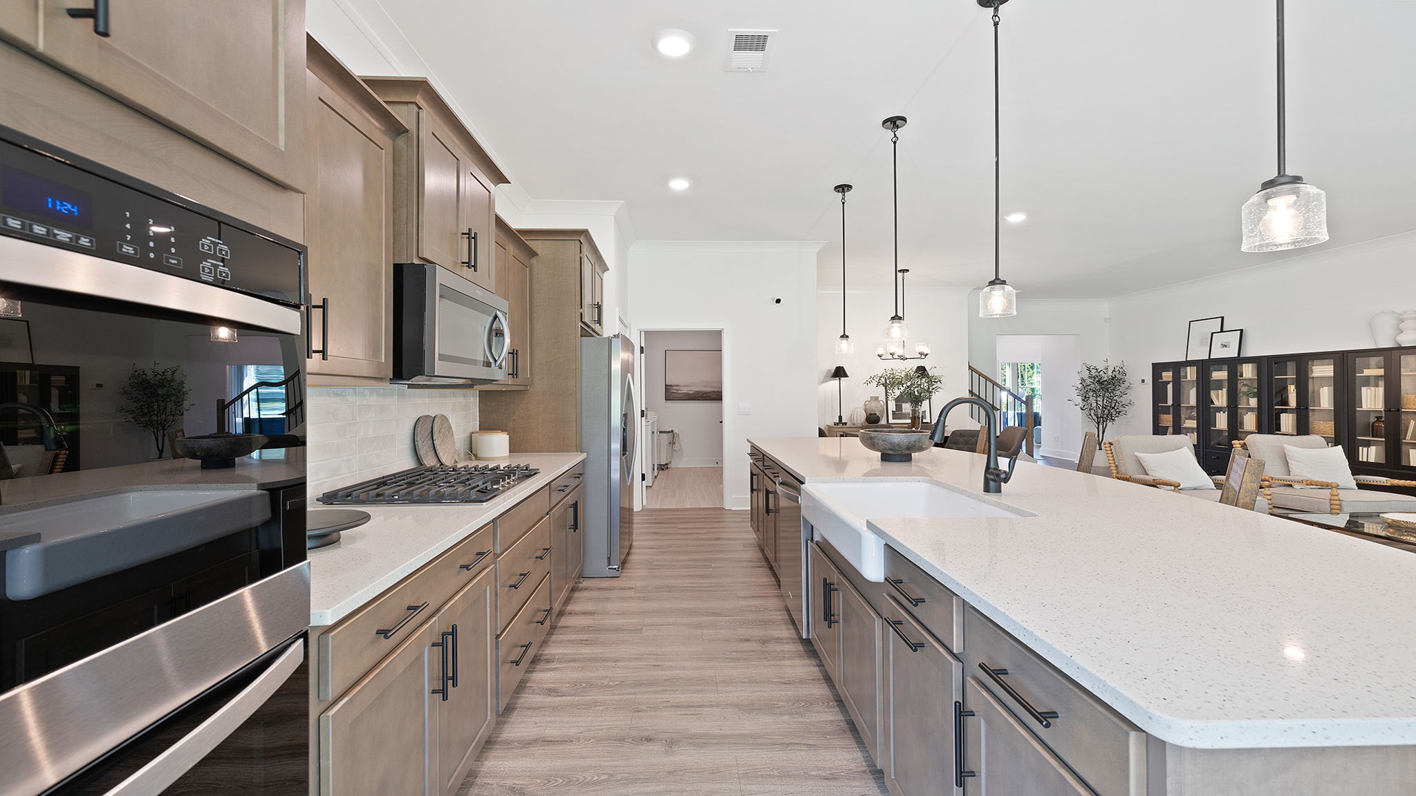 Kitchen and island with quartz countertops and stainless steel appliances.
