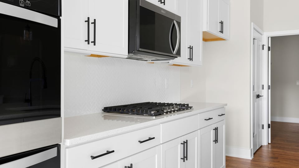 Kitchen and island with quartz countertops.