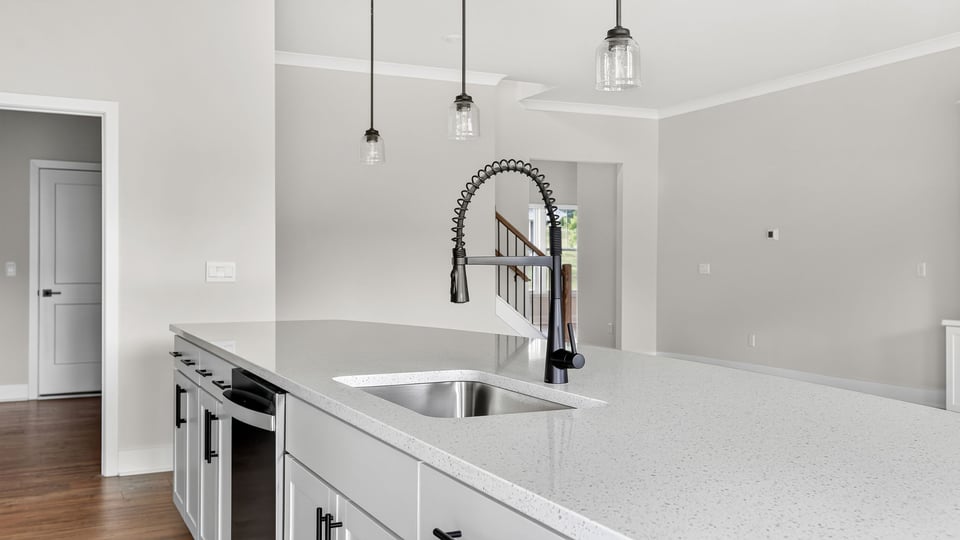 Kitchen and island with quartz countertops.
