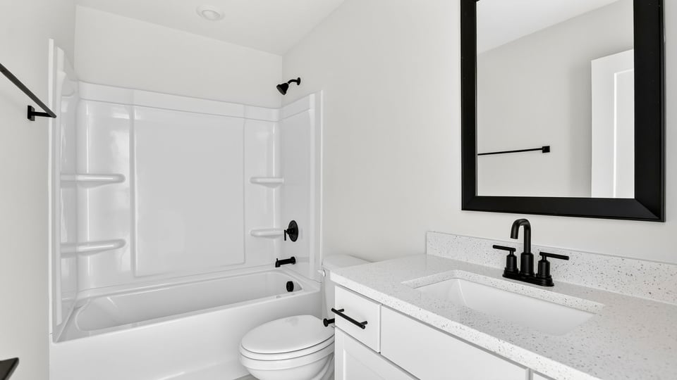 Bathroom with single vanity sink and bathtub.