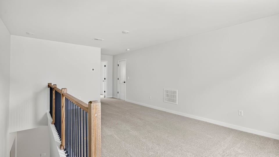 Loft area with carpet.