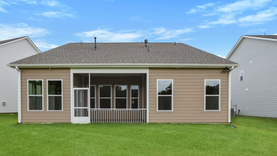 Back of home with covered patio.