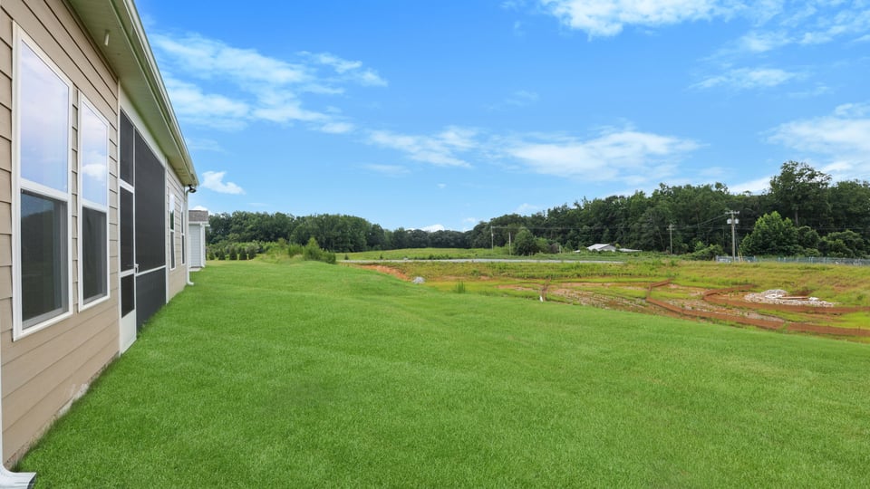 Back of home with large backyard.