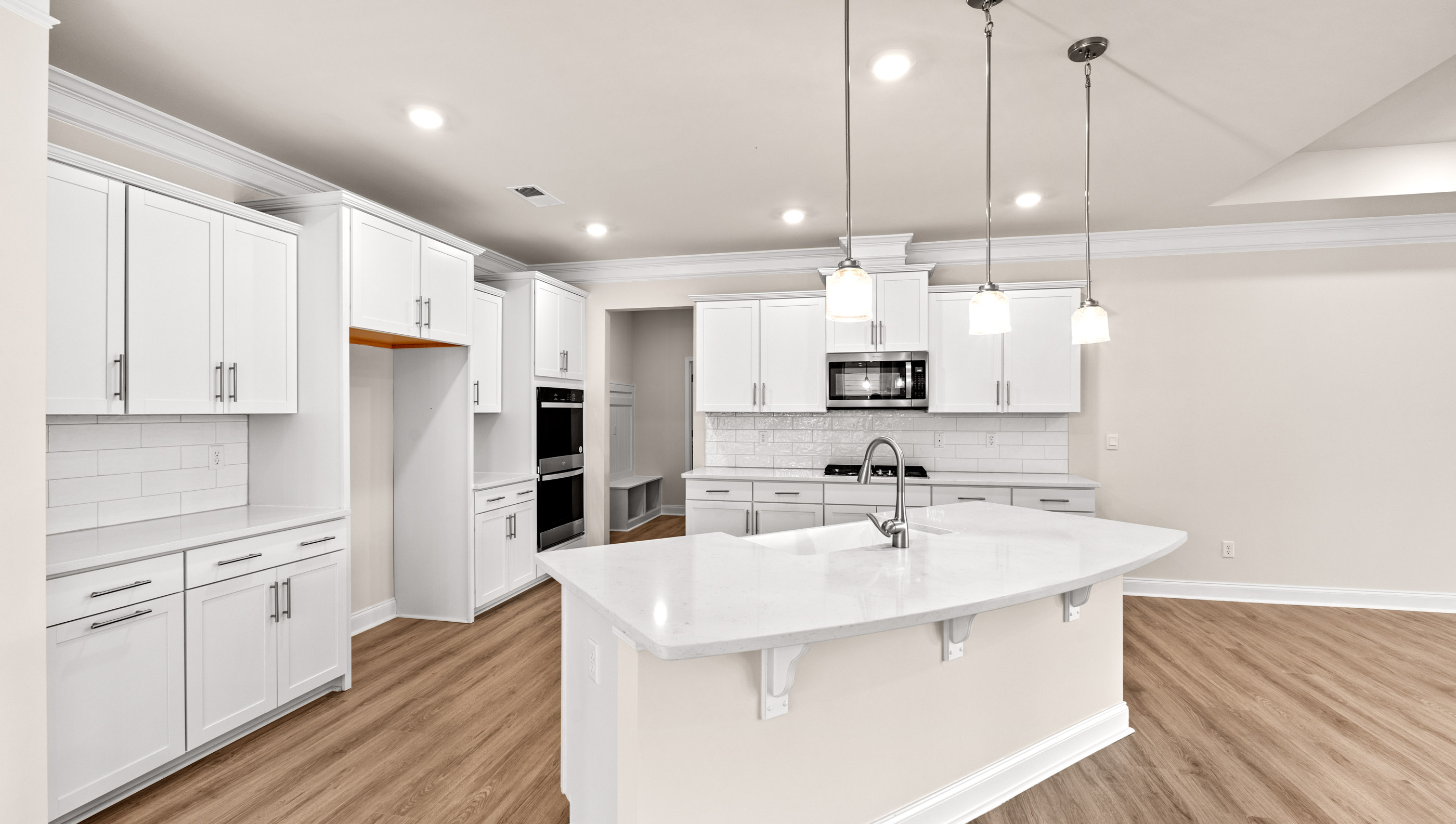 Kitchen with quartz countertops and stainless steel appliances.