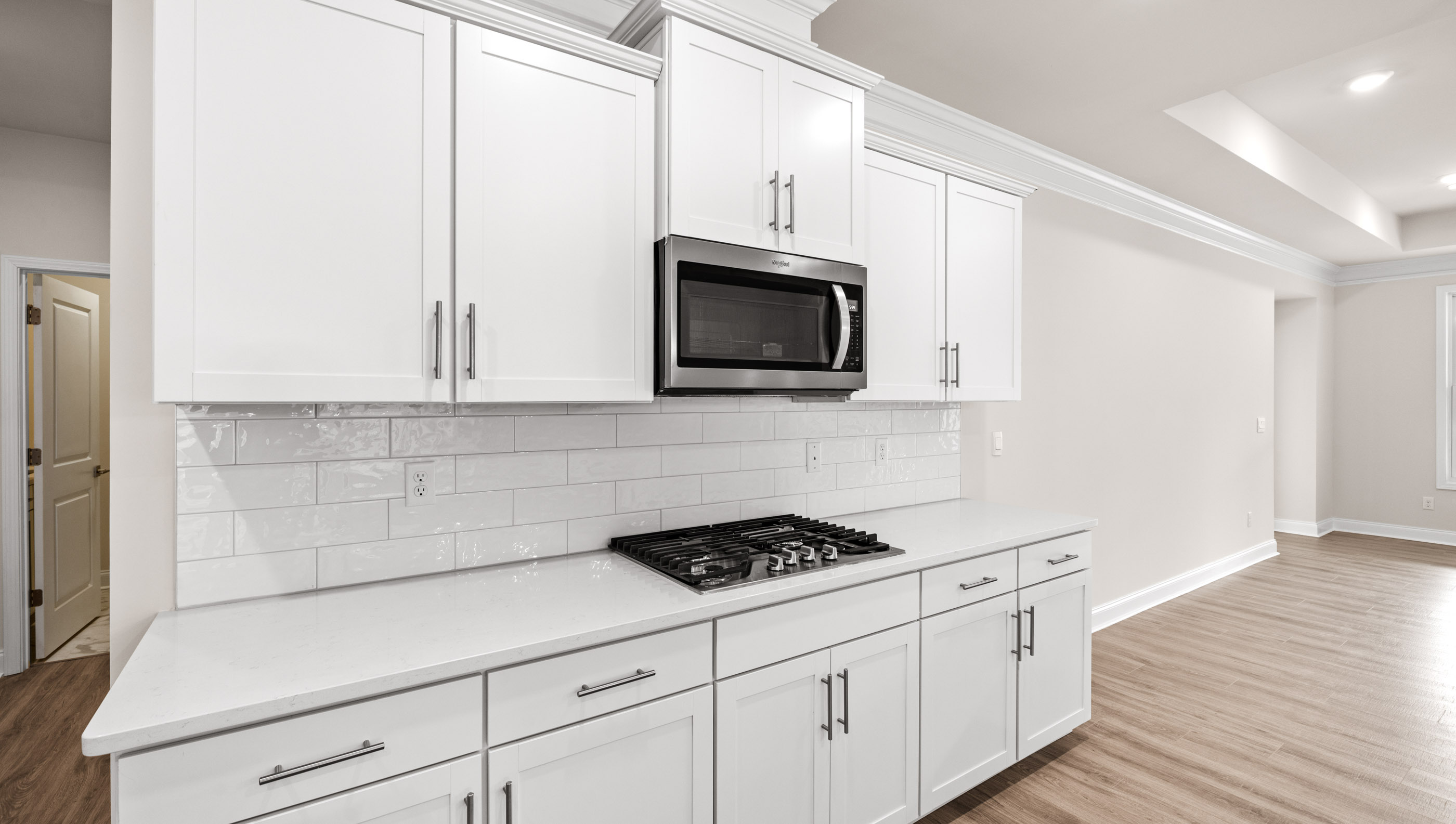 Kitchen with quartz countertops and stainless steel appliances.
