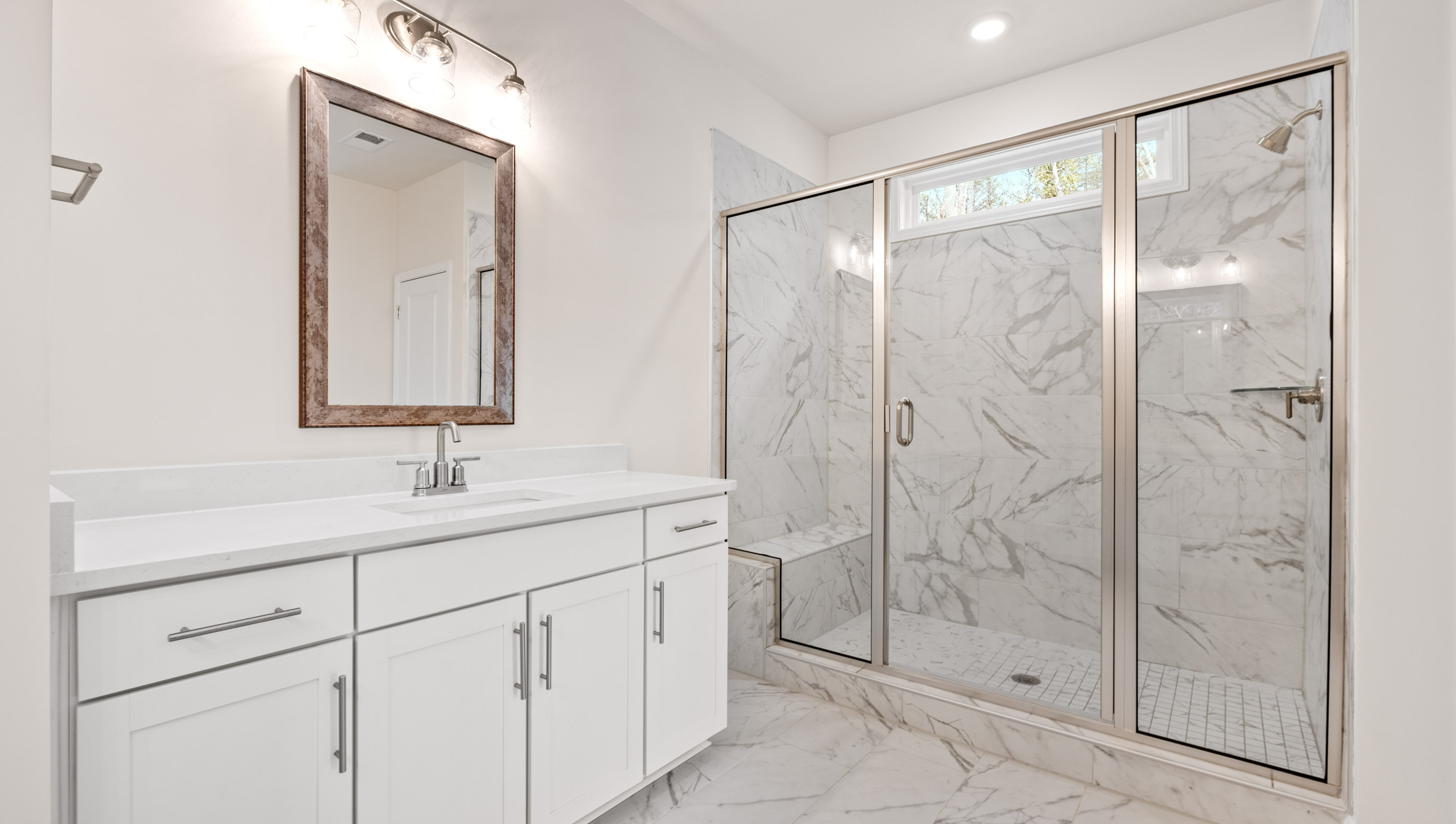Bathroom with vanity and walk in shower.