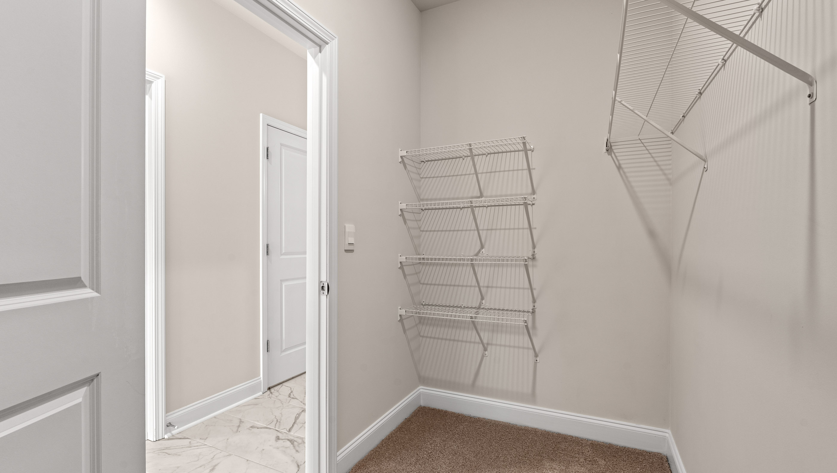 Walk in closet with hanging shelves.