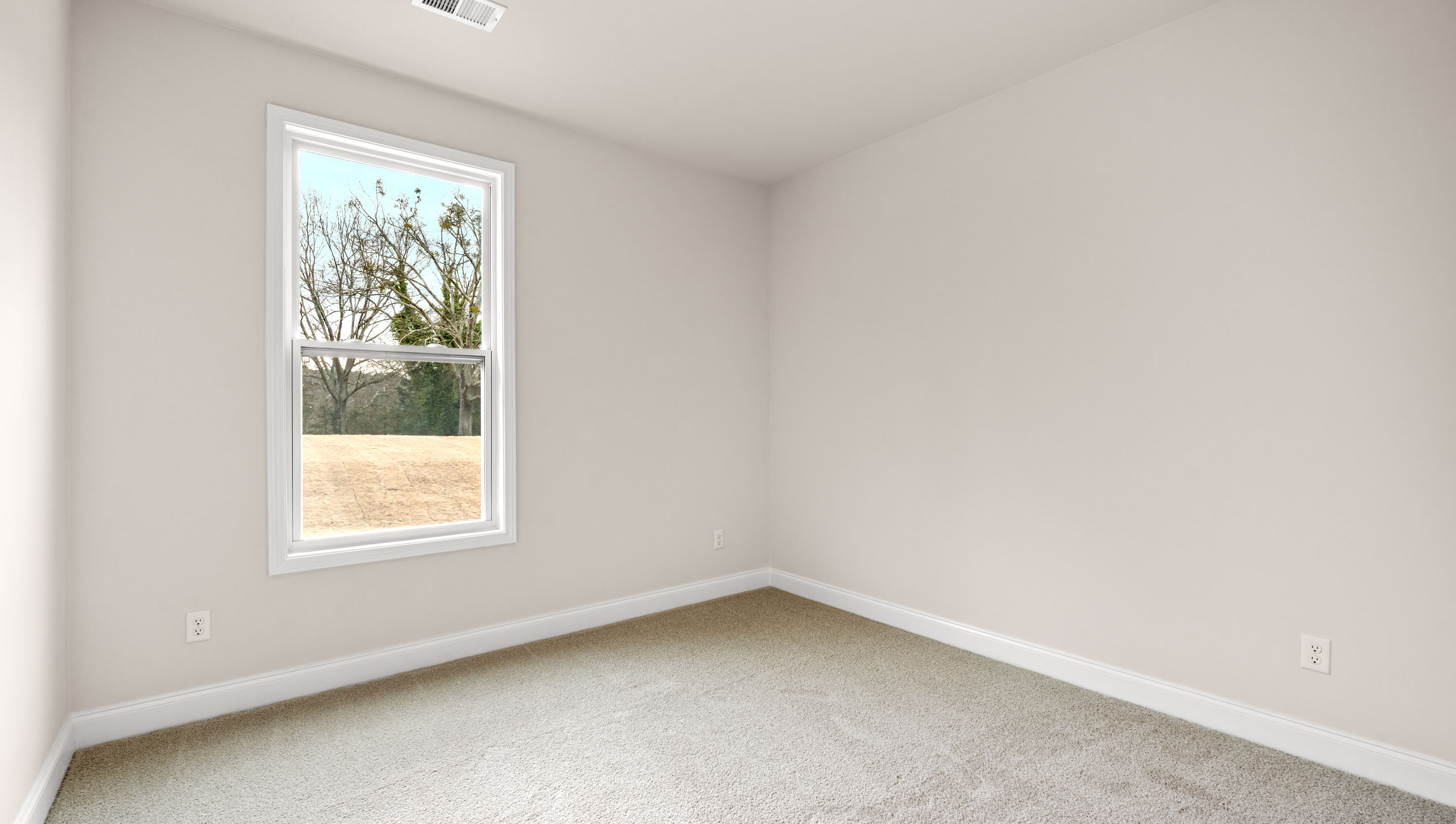 Bedroom with carpet and window.