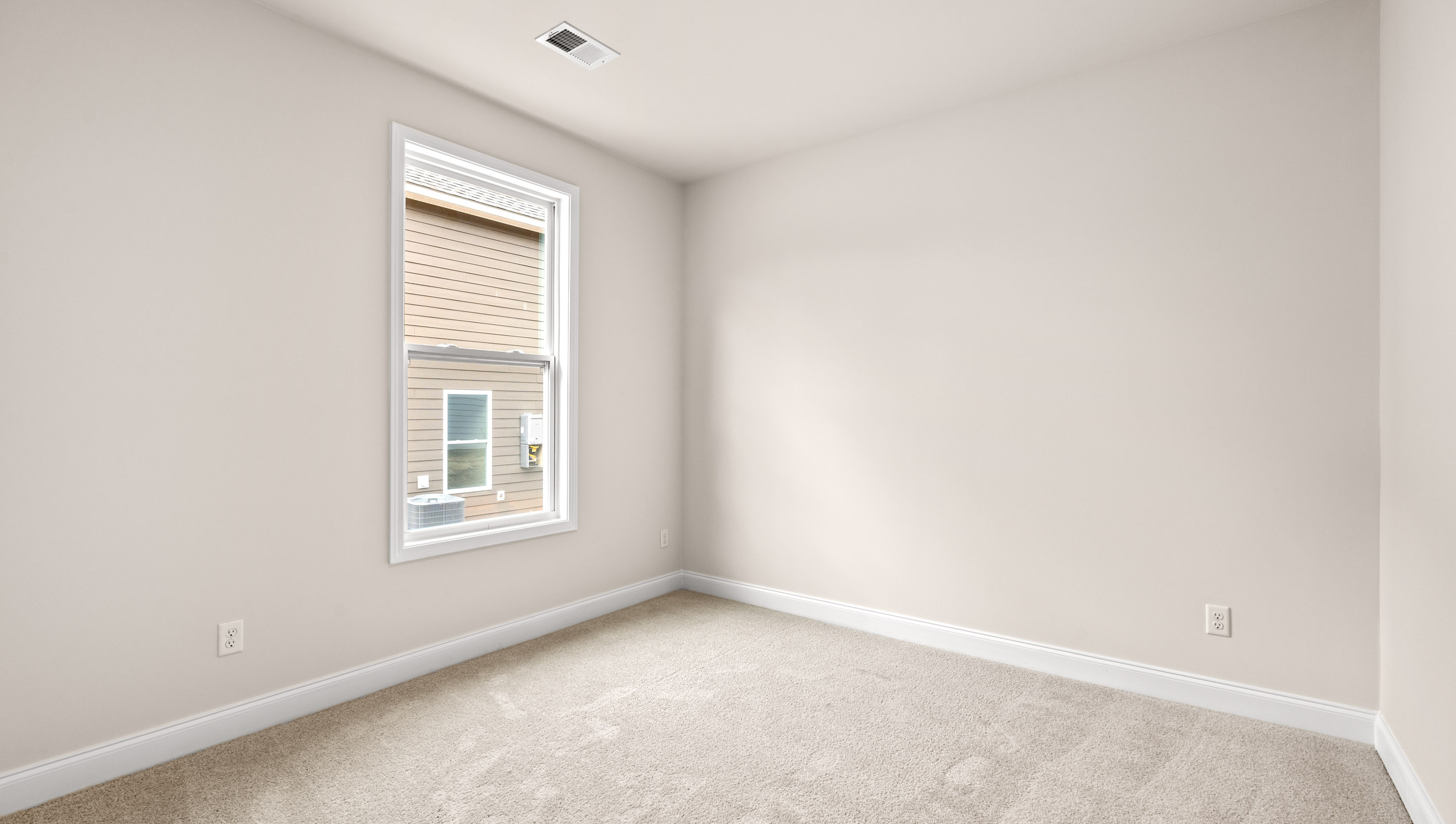 Bedroom with carpet and windows.