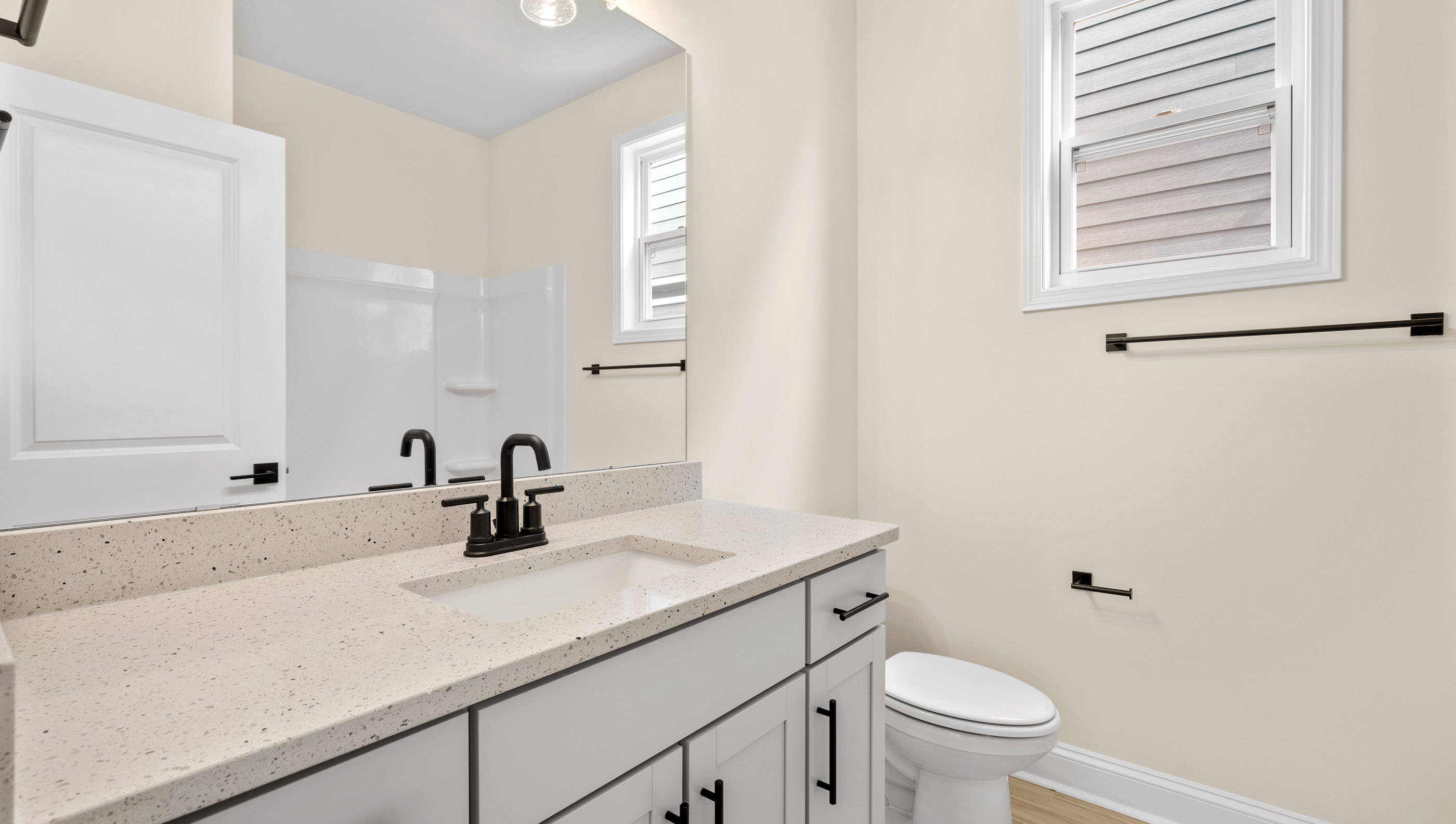 Bedroom with vanity and tub.