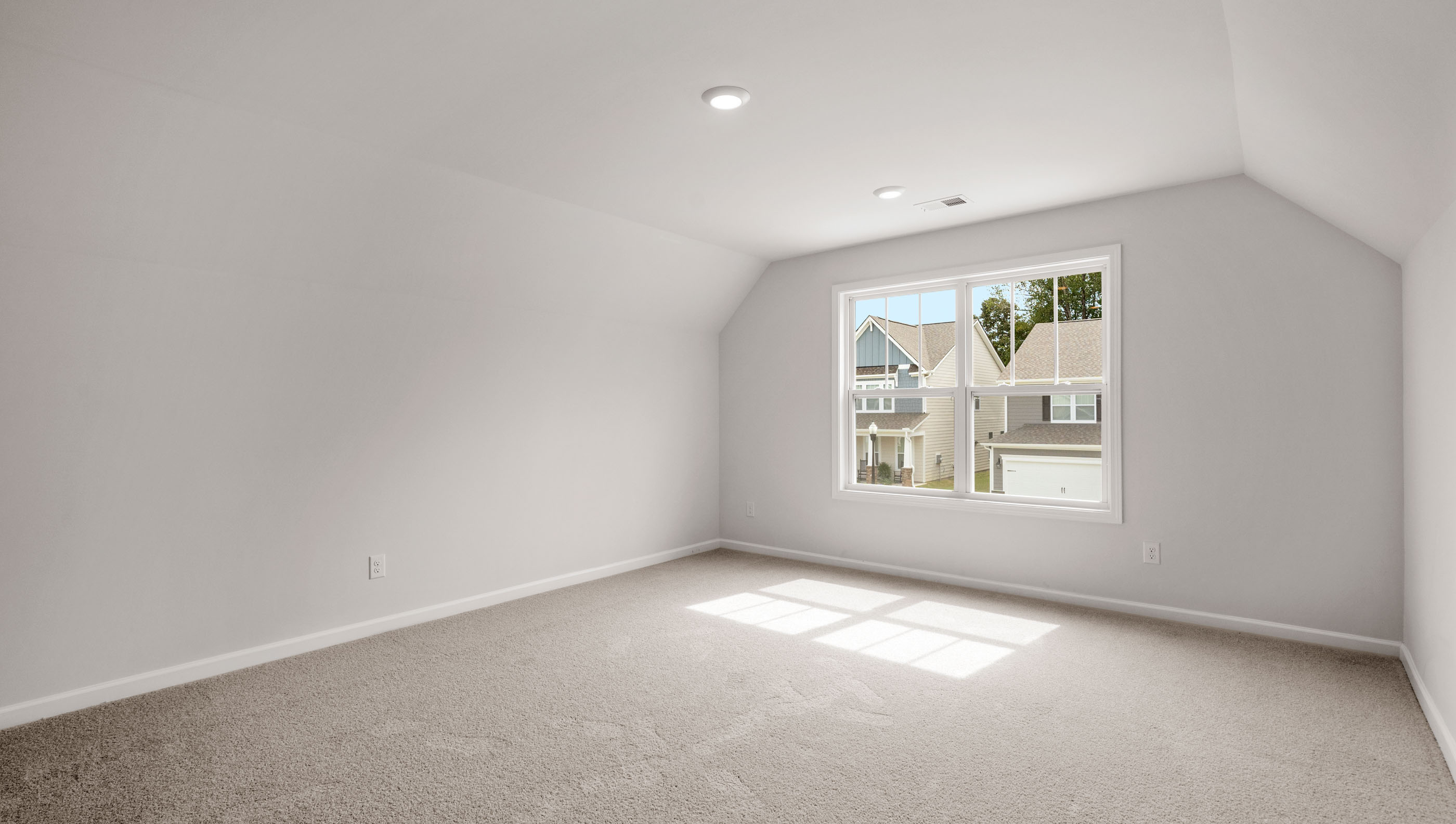 Bedroom with carpet and window.