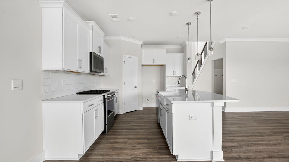 Kitchen and island with quartz countertops.
