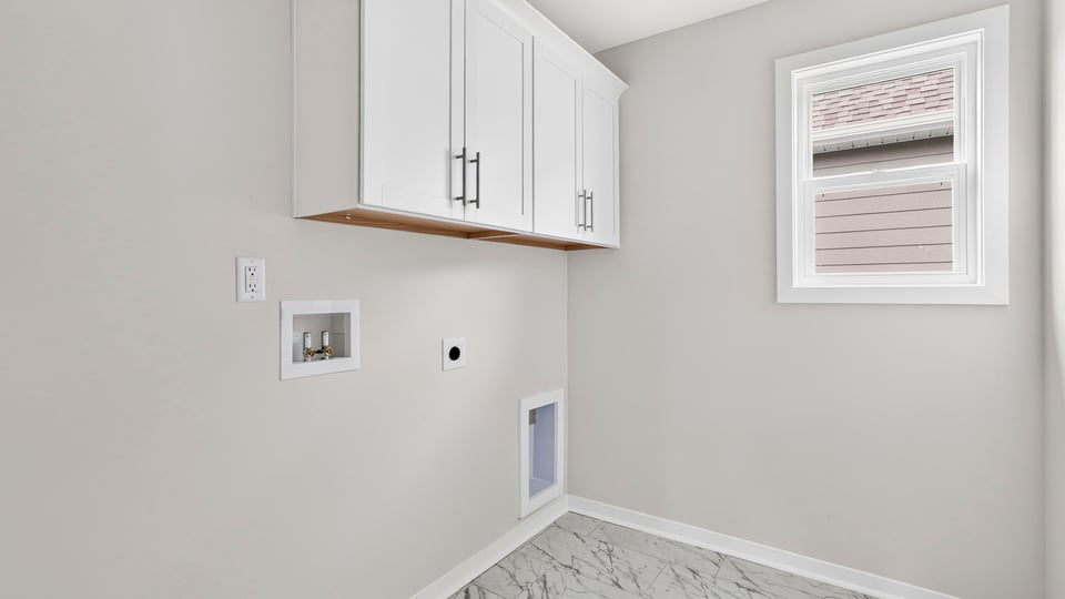 Laundry room with hanging storage racks.