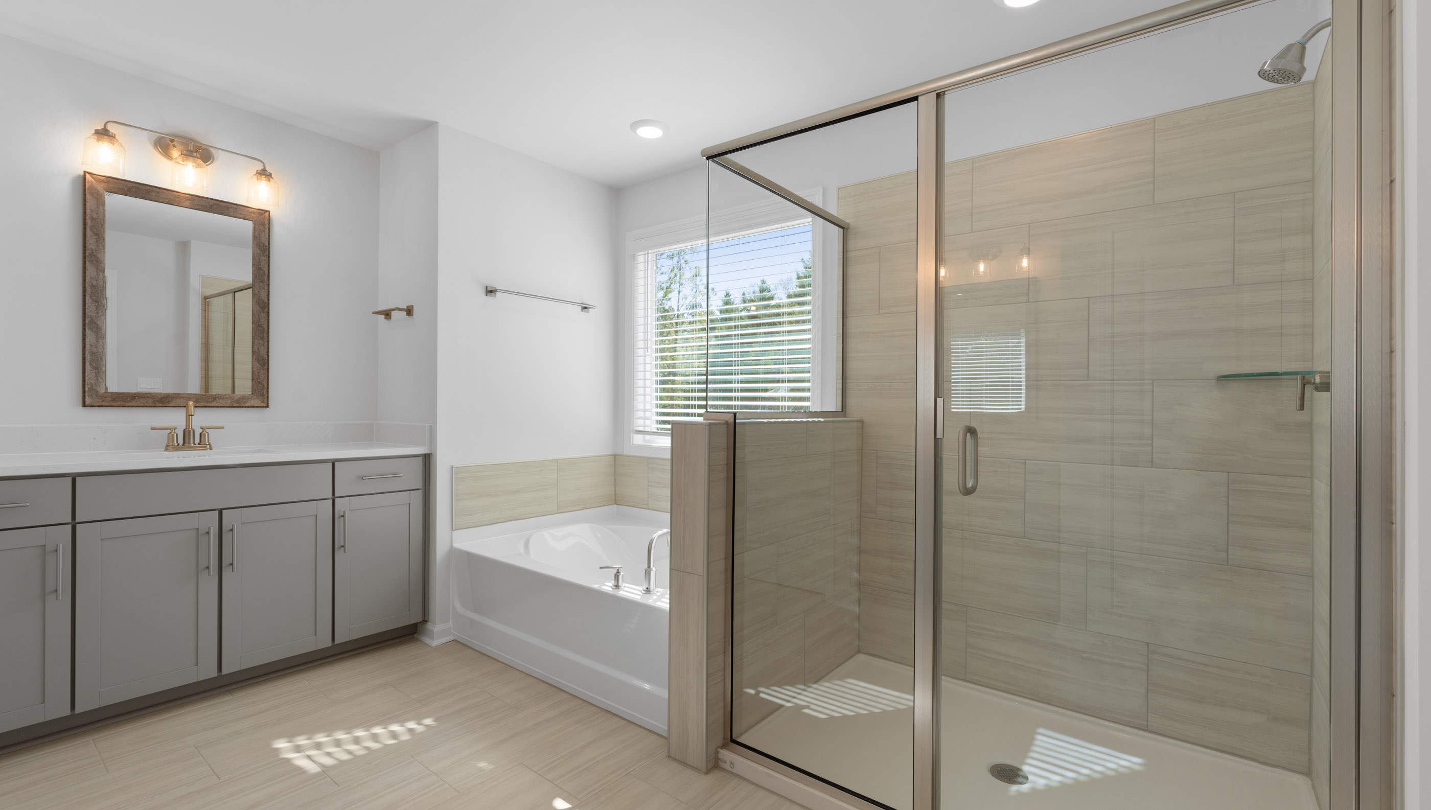 View of primary bathroom with gorgeous walk-in tiled shower and soaking tub.