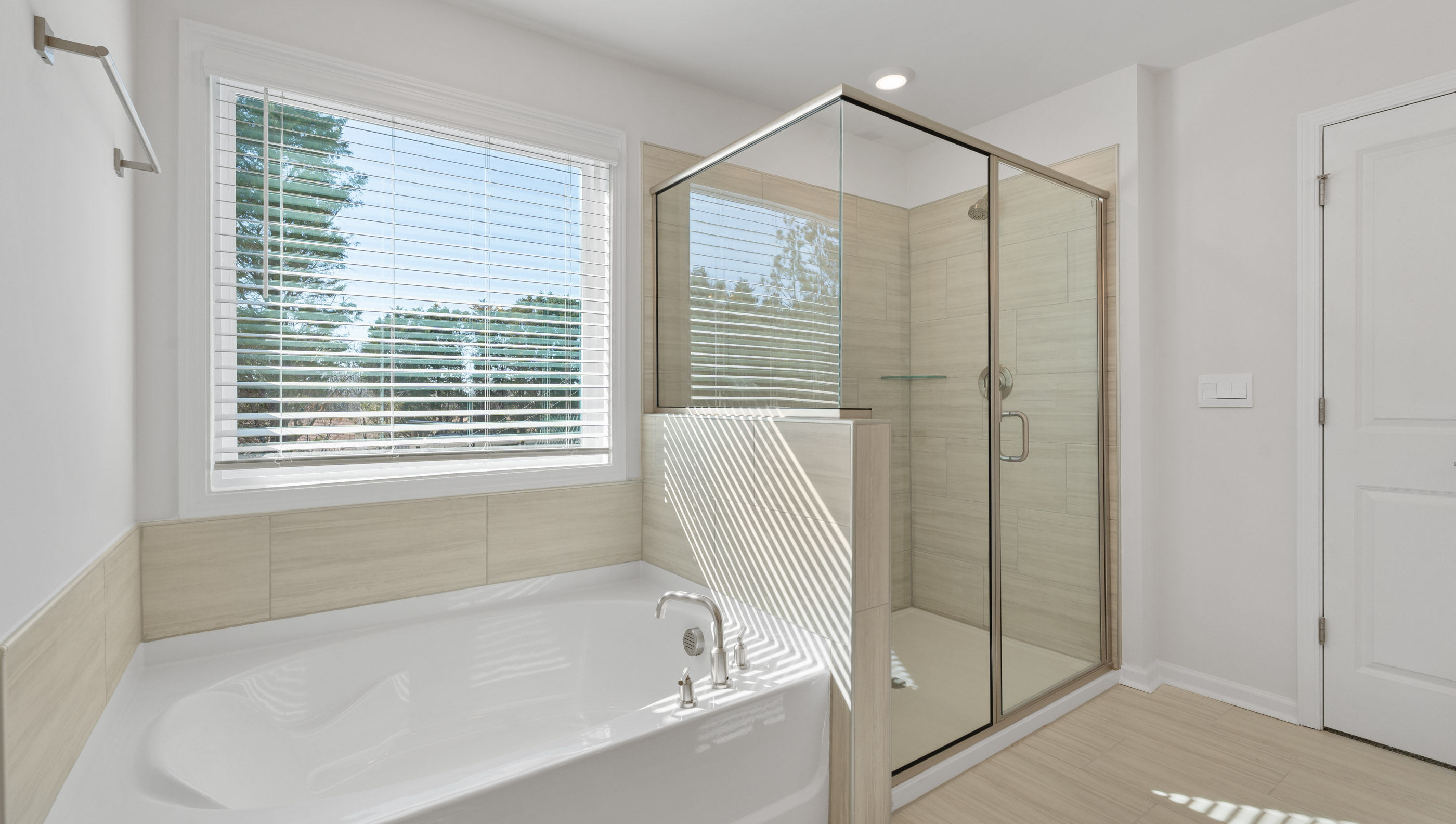 View of primary bathroom with gorgeous walk-in tiled shower, soaking tub and her vanity area