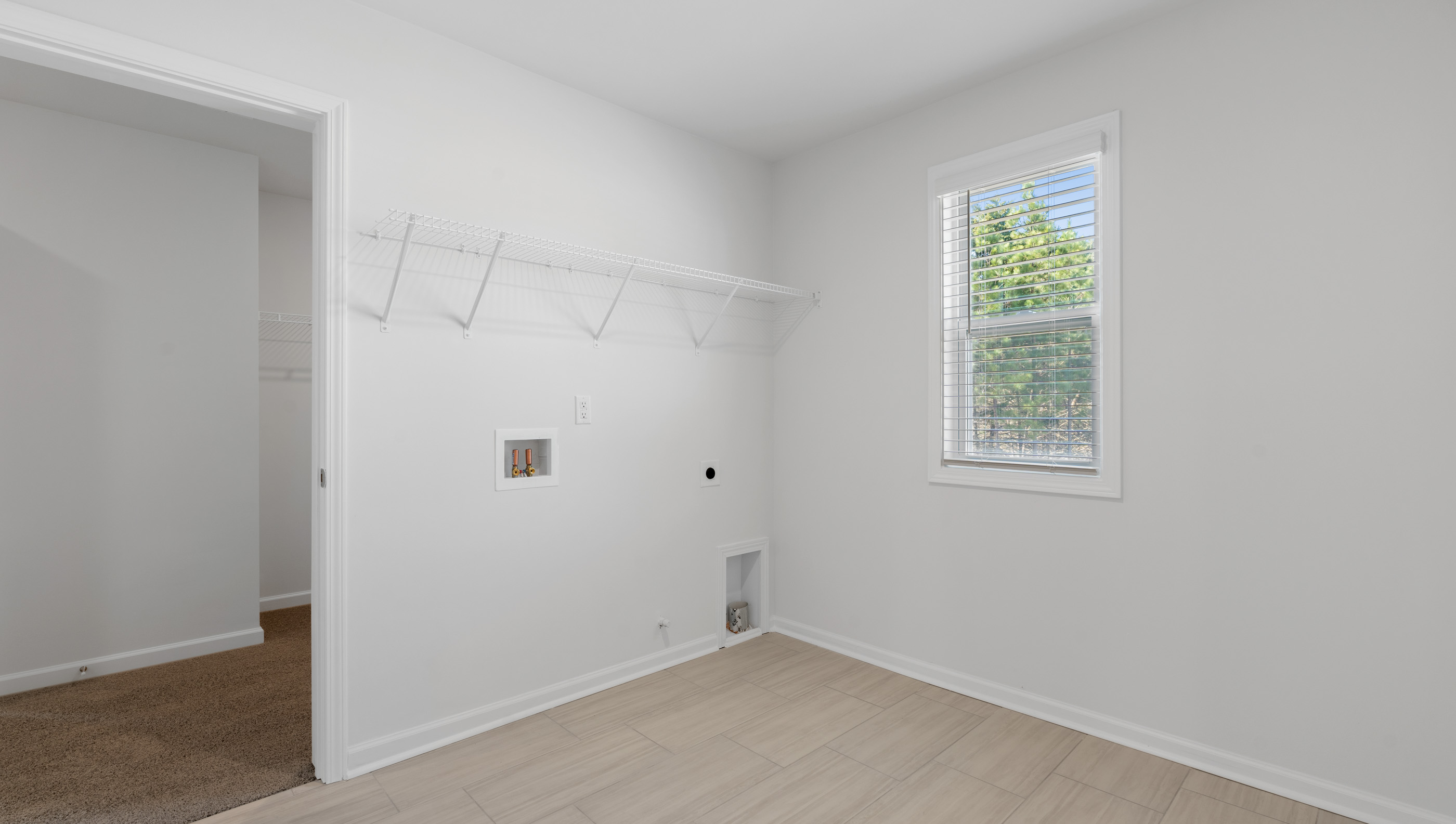View of primary bedroom closet with his and hers closet hanging areas